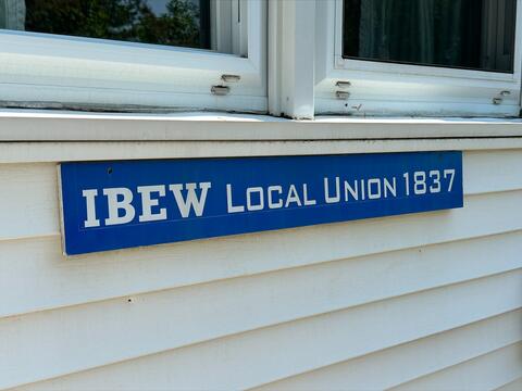 IBEW Local Union 1837 sign on house siding by IBEW 1837