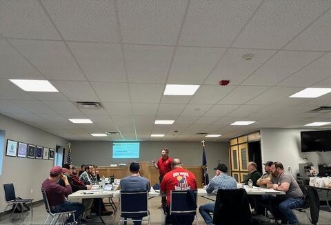 Instructor leading a negotiation training session in a conference room by IBEW 1837
