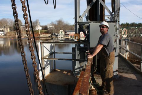 Worker on dam platform beside the river by IBEW 1837