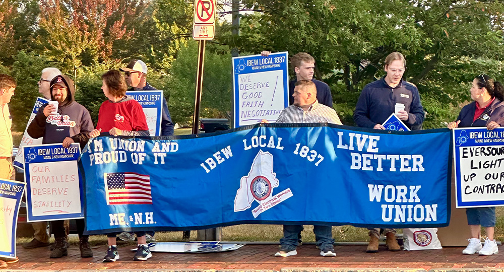 IBEW Local 1837 members holding a blue union banner by IBEW 1837