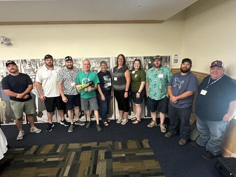 Group of IBEW 1837 members standing indoors by IBEW 1837