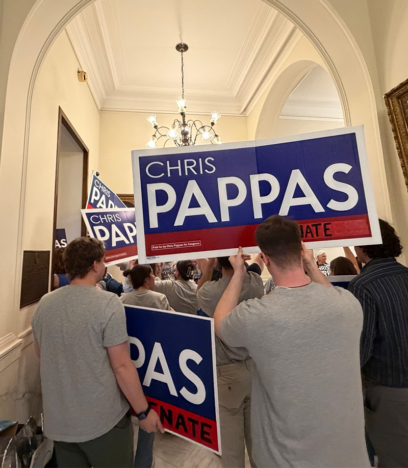 People holding Chris Pappas campaign signs in a hallway by IBEW 1837