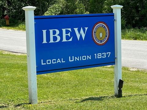 IBEW Local Union 1837 sign on white posts by IBEW 1837
